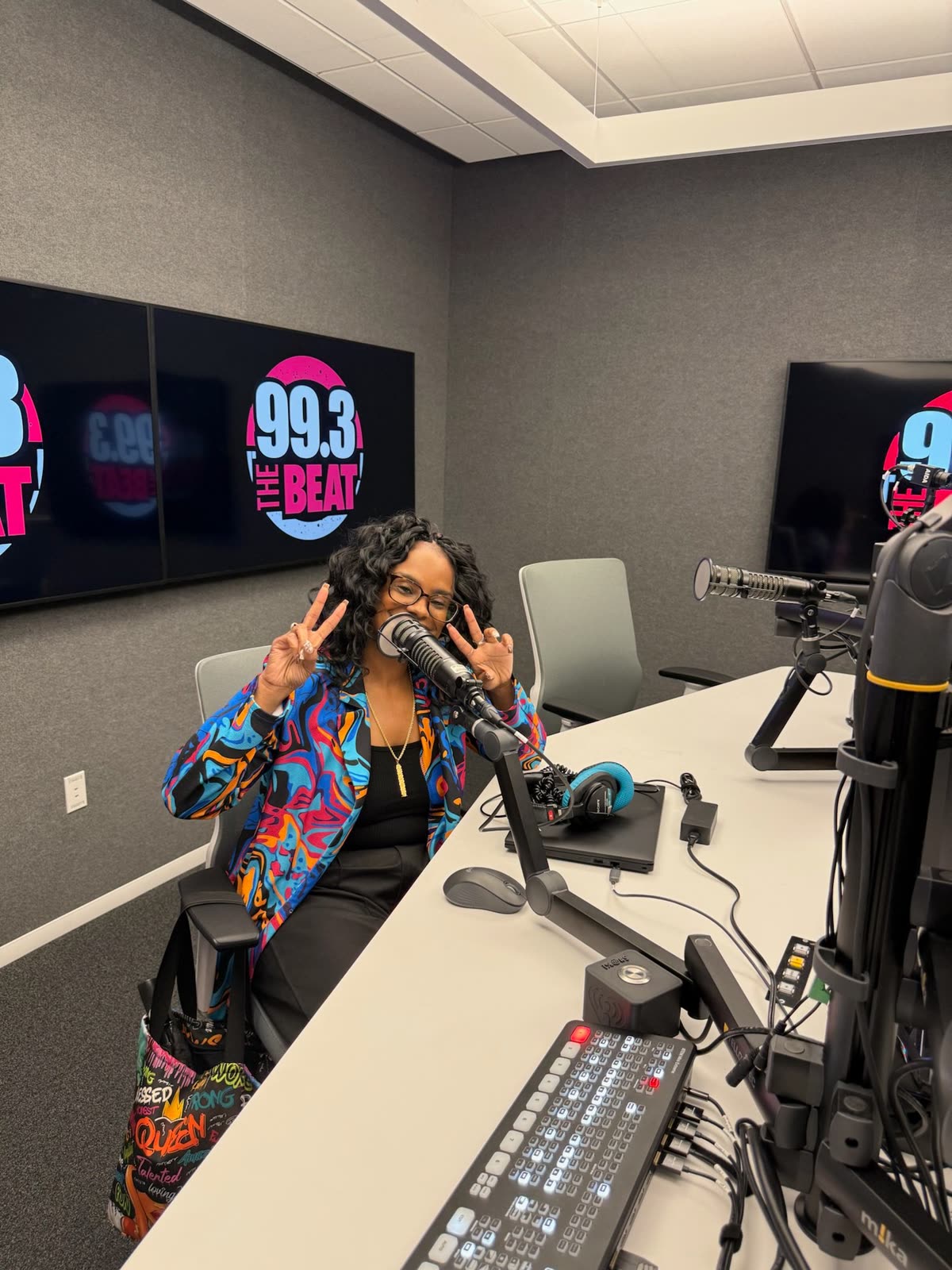 Cara at the microphone in the 99.3 The Beat radio studio