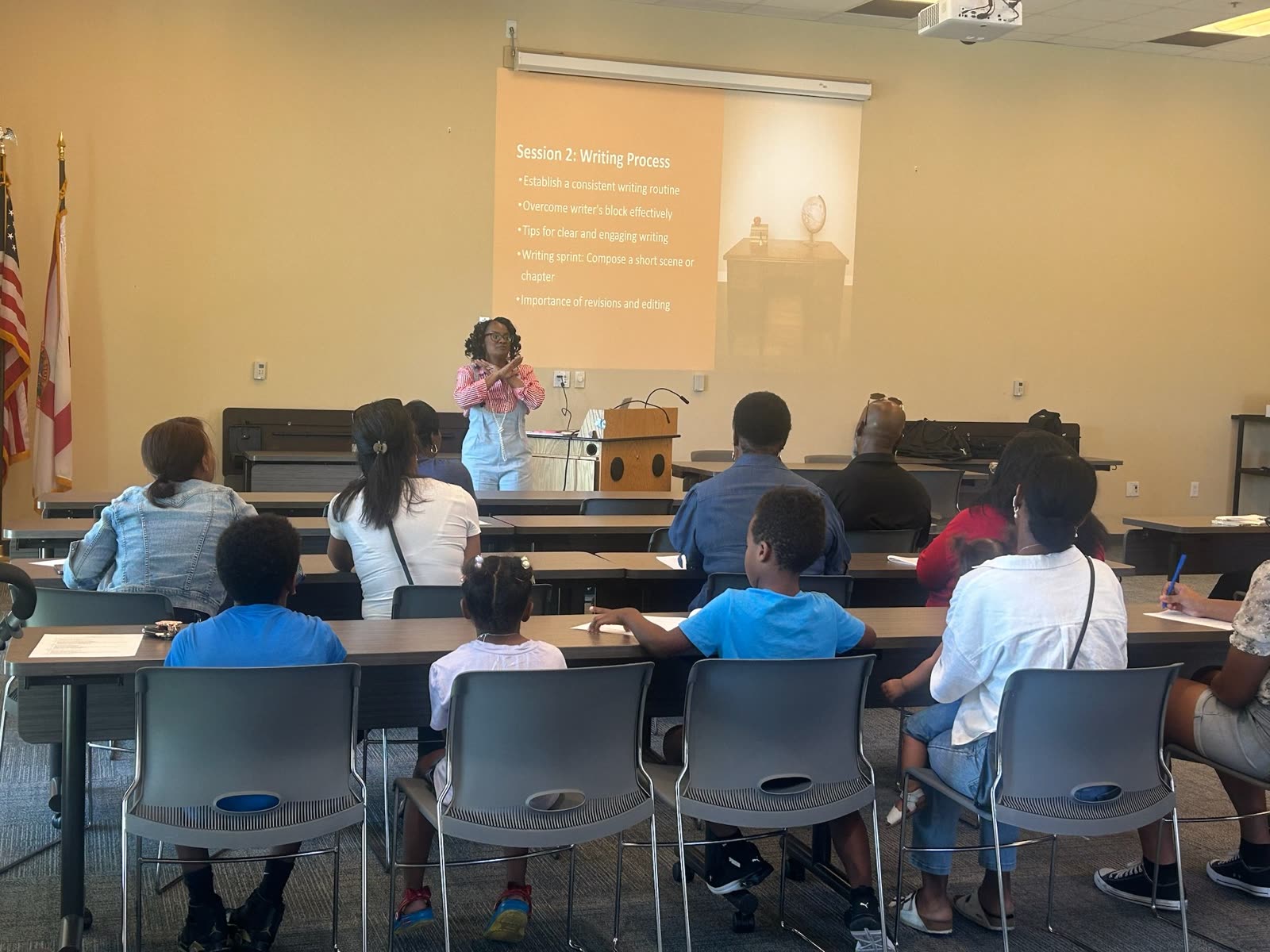 Cara leading a writing workshop in front of a projected slide
